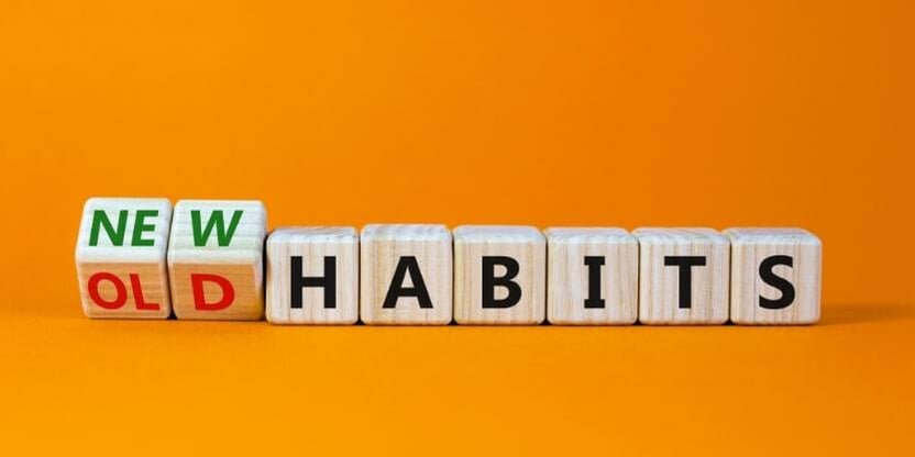 Wooden toy blocks spell out "new habits".