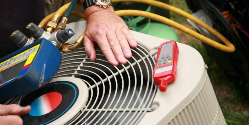 A man tests an air conditioner. 