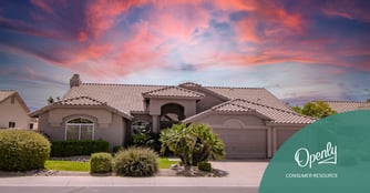 A southwestern style house sits against a background of a colorful sunset. 