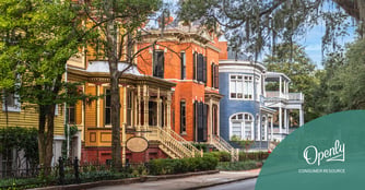 A photo of yellow, orange, and blue two-story houses along Whitaker Street in Savannah, Georgia.