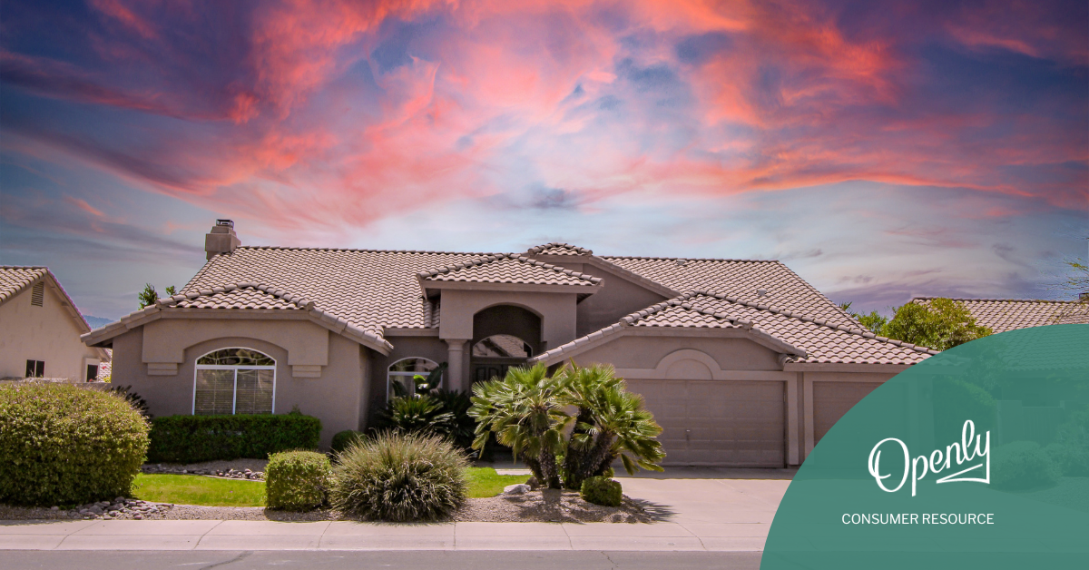 A southwestern style house sits against a background of a colorful sunset. 