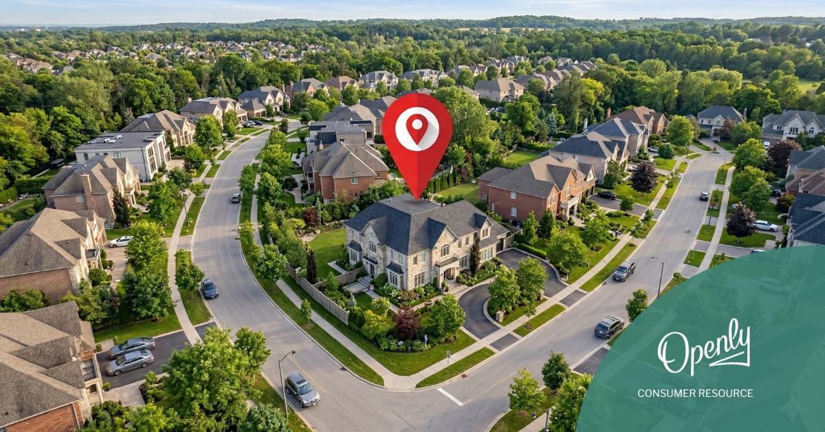 An overhead view of a residential neighborhood with a map pin over a large multi-story house. 